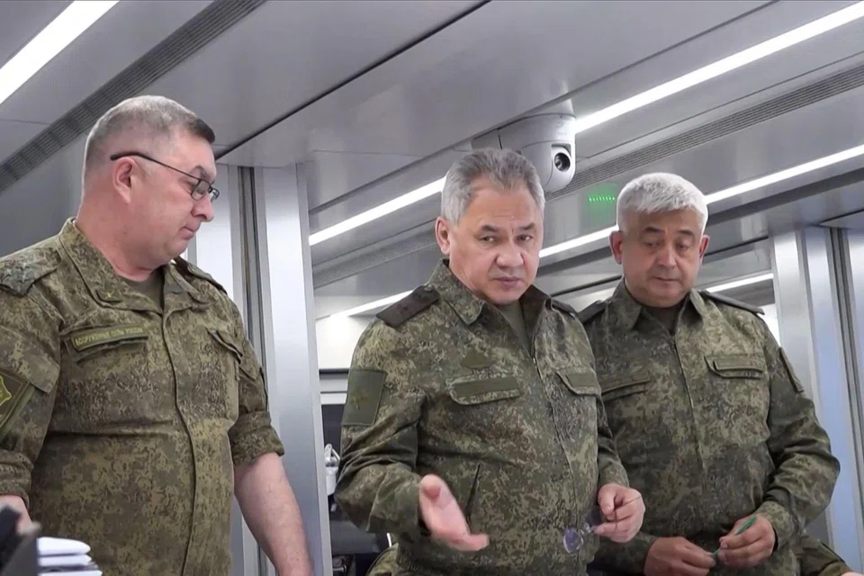 This undated video footage released by the Russian Defence Ministry on June 26, 2023 shows Defence Minister Sergei Shoigu (C) with officers at an undisclosed location. The mutineers had demanded he be sacked, leading to speculation that his removal might have been part of the arrangement that ended the revolt.