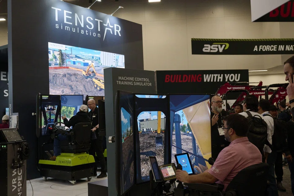 Attendees testing the Tenstar Simulation heavy equipment operator simulator during the ConExpo; much like economists can’t agree whether the US is barrelling towards a recession, the construction industry is split as to whether the good times will last. 