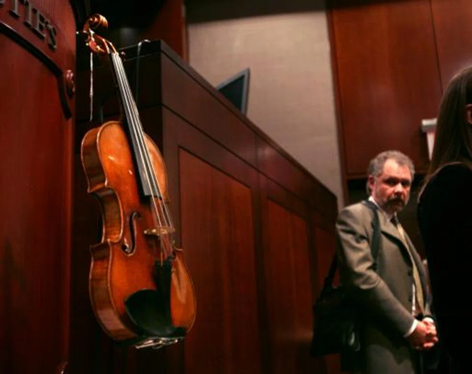 FILE PHOTO: Ric Heinl with the Stradivari violin he bought at a Christie's auction in New York. This violin, made in 1729, cost him US$2.4 million.  