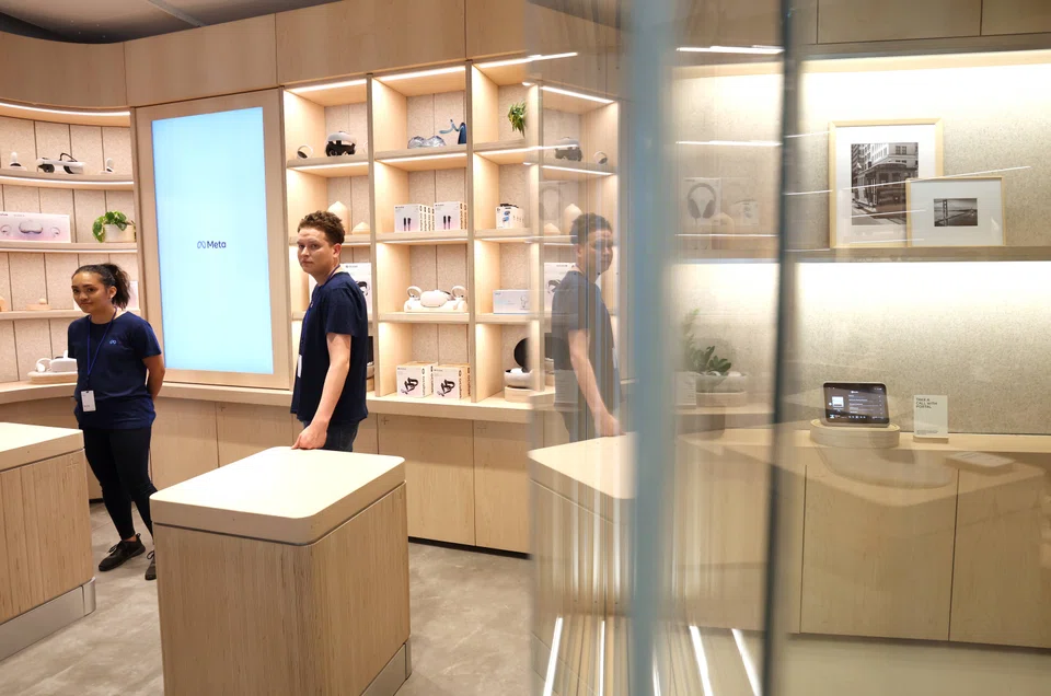 Meta employees stand in the showroom during a media preview of the new Meta Store on May 4, 2022, Burlingame, California.