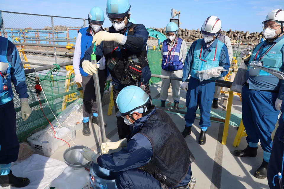 Tepco officials sampling water from the upper-stream storage
ahead of the second discharge of ALPS treated wastewater at the Fukushima Daiichi nuclear power plant in Okuma, Fukushima prefecture, Oct 3, 2023.
