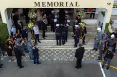 The coffin of the late Brazilian football star Pele arriving at the Santos' Memorial Cemetery after a funeral procession in Santos, Sao Paulo state, Brazil. His remains will be interred in a mausoleum contained within a vertical cemetery.