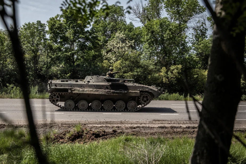 A Ukrainian armoured personnel carrier is driven along a road leading to Sievierodonetsk, in eastern Ukraine, on Monday, May 30, 2022. The battered city of Sievierodonetsk has been in Russia's cross hairs for weeks, pounded by the full might of Moscow's artillery. 