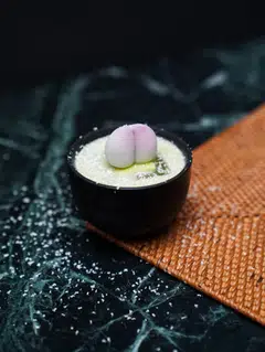 The Matcha cocktail at kaiseki restaurant and bar GOHO is topped with a red bean mochi and white chocolate shavings.