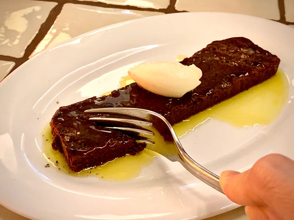 Olive oil chocolate slice features dense cake drizzled with olive oil.