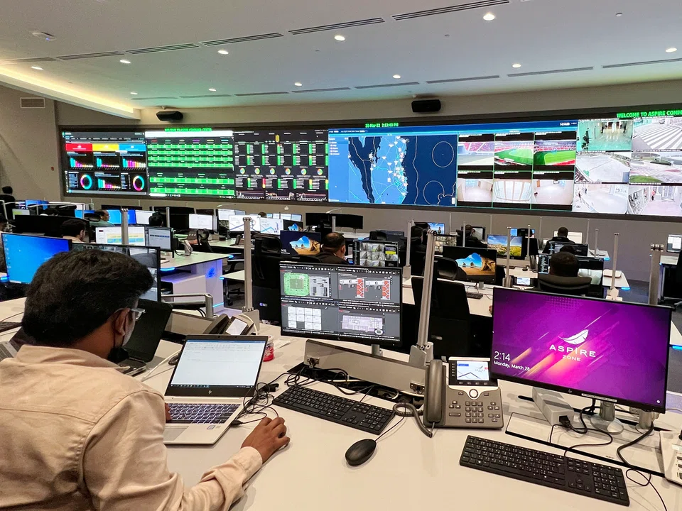 Staff work on March 28, 2022 at the Aspire security command centre for the Fifa World Cup Qatar 2022, near Khalifa International stadium in Doha, where operation and security teams will be able to monitor all the stadiums during the World Cup. 