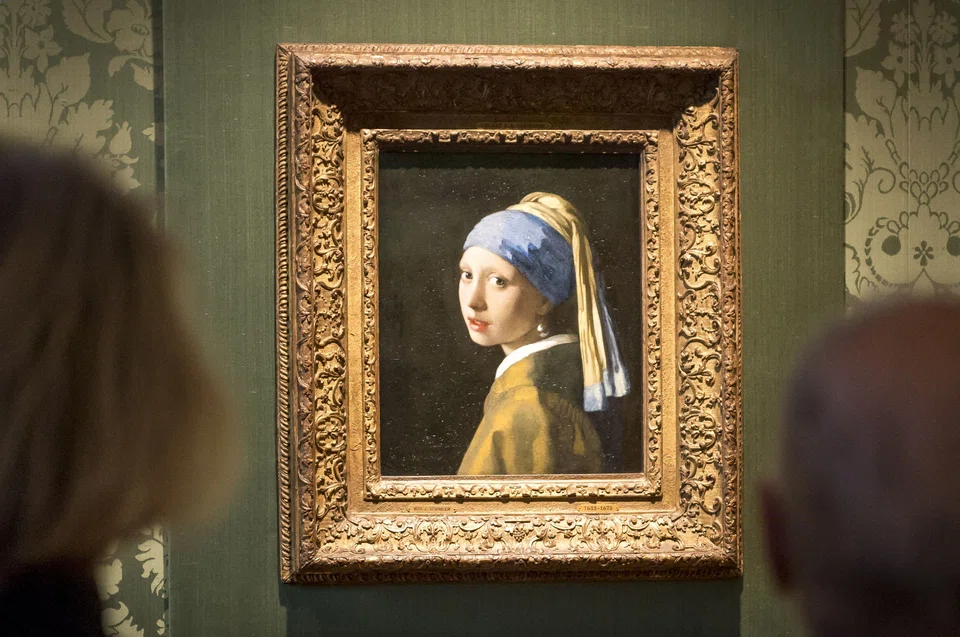 Dutch police arrested three people after climate activists targeted Johannes Vermeer's painting "Girl with a Pearl Earring". One of them glued his head to glass covering the painting.