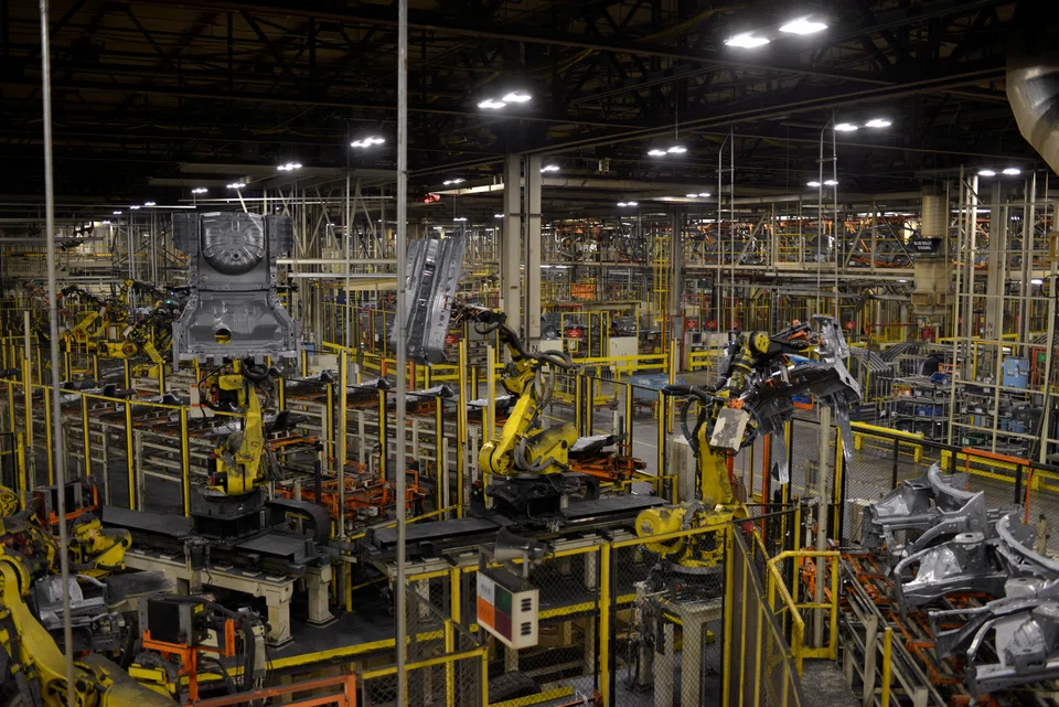 Robotic arms bring together car frames for welding at Nissan Motor Co's manufacturing plant in Smyrna, Tennessee. An index of new orders shrank for a third-straight month to a more-than-two-year low, and a measure of international trade fell, illustrating softer demand as central bankers around the world ratchet up interest rates to fight inflation.