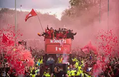 Liverpool supporters greet their team during an open top bus parade where the English Premier League football club displays the FA Cup and the Carabao Cup trophies through the streets of Liverpool, Britain, May 29, 2022.