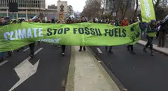 People protest against fossil fuels in Brussels, Belgium, Dec 3, 2023. The protest, coinciding with the COP28 in Dubai, is calling for urgent measures to combat climate change. 