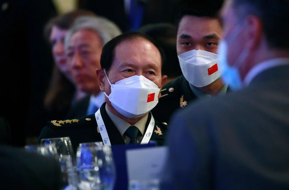 China’s Minister of National Defense General Wei Fenghe (C) speaks to an aide during the Opening of the International Institute for Strategic Studies (IISS) Shangri-la Dialogue at the Shangri-la hotel in Singapore, 10 June 2022. 