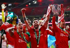 Manchester United's Antony and Bruno Fernandes celebrate with the trophy after winning the Carabao Cup at Wembley Stadium, London, Britain, Feb 26, 2023. 