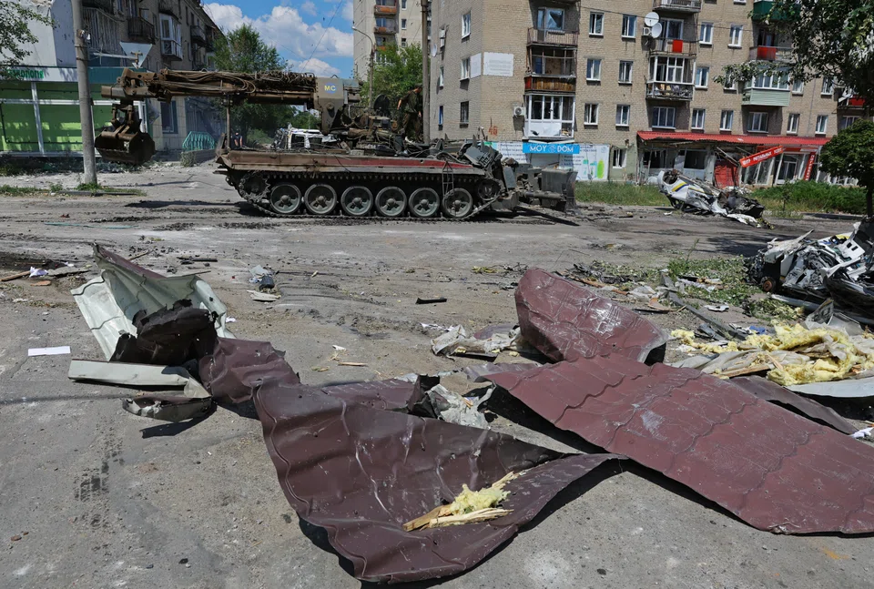 Service members of pro-Russian troops ride on top of a combat engineering vehicle in the city of Lysychansk that was captured on Sunday (July 3) in the Luhansk region. 
