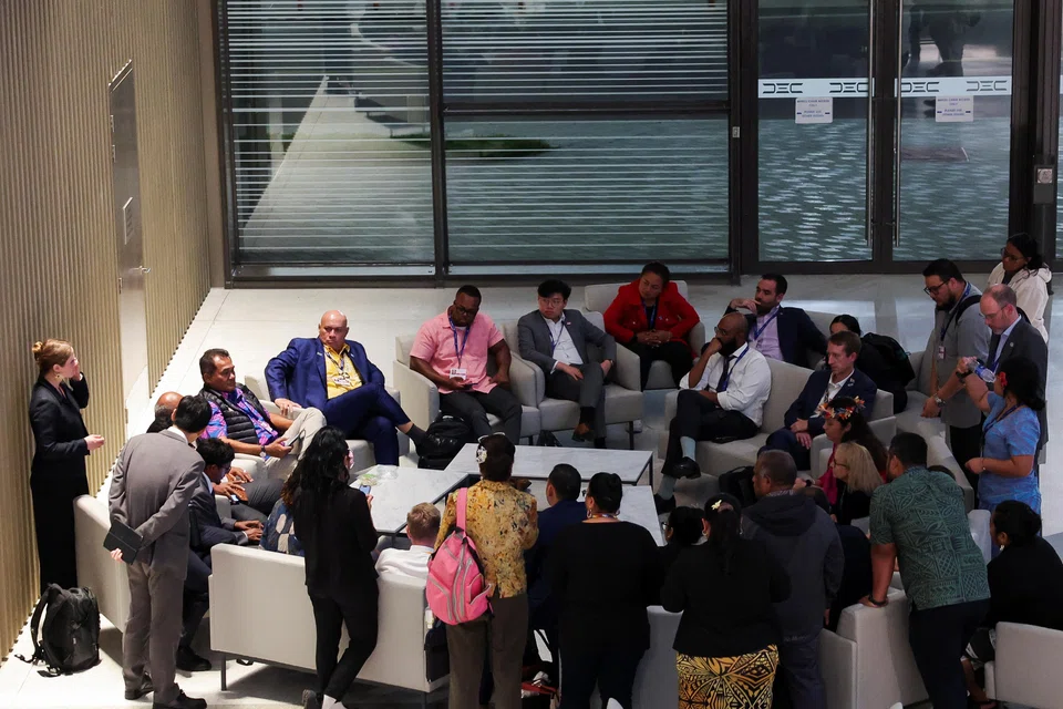 Representatives negotiate a draft deal during the United Nations Climate Change Conference in Dubai, United Arab Emirates, Dec 12, 2023.