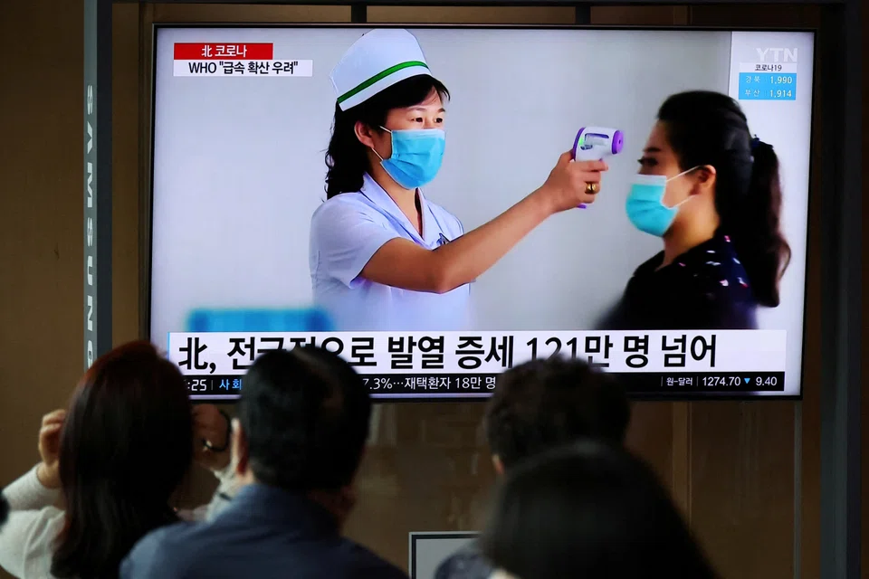 People watch a TV broadcasting a news report on the Covid-19 outbreak in North Korea, in Seoul, South Korea, May 17, 2022. Kim Jong Un on Thursday declared victory in the battle against Covid-19, ordering a lifting of maximum anti-epidemic measures imposed in May.