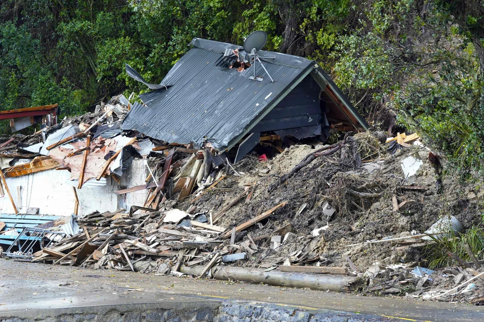 Homes are damaged after a storm battered Titirangi, a suburb of New Zealand's West Auckland area, on Feb 13.