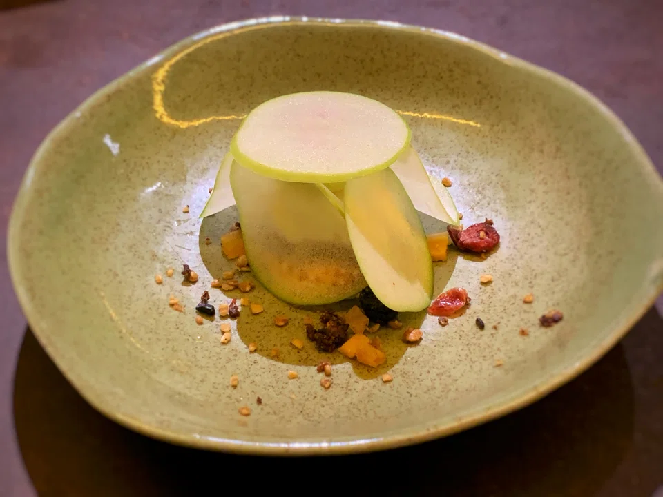 Smoked yoghurt ice cream surrounded by sweet green apple slices.