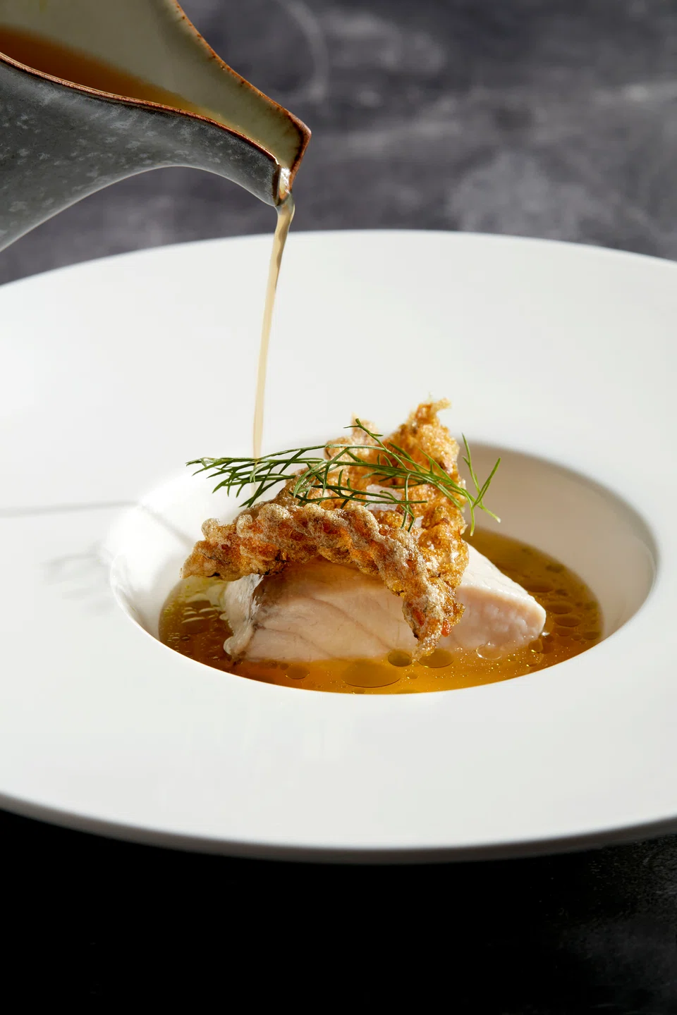 Steamed and fried barramundi in a Thai-style broth.