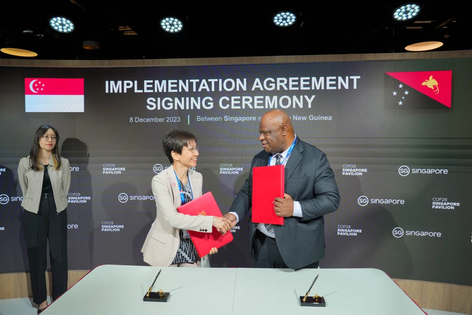 Minister for Sustainability and the Environment Grace Fu and Papua New Guinea Minister of Environment, Conservation and Climate Change Simo Kilepa at a ceremony at COP28 in August 2023 launching Singapore's cooperation with over 20 countries to create a supply of carbon credits.