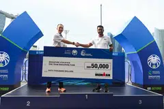 SAA president Lien Choong Luen (left) receiving the S$50,000 cheque from The Ironman Group's Santoz Kumar.