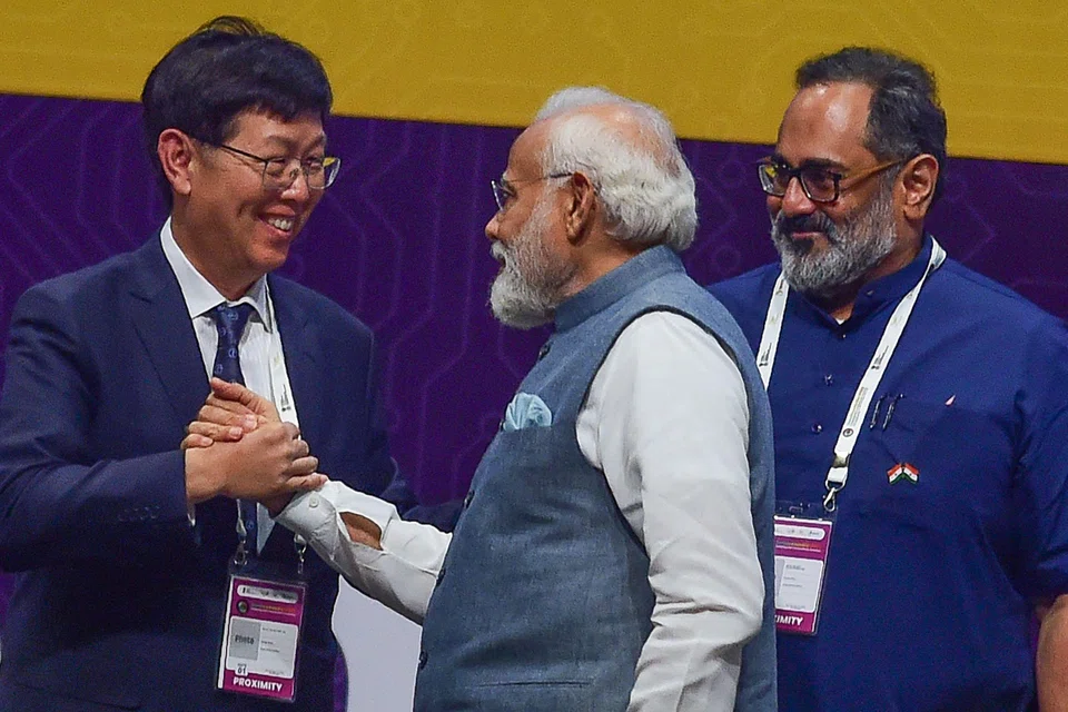 Foxconn chairman and CEO Young Liu (left) greets Indian Prime Minister Narendra Modi (centre), during SemiconIndia 2023, at Mahatma Mandir in Gandhinagar, India on July 28, 2023. 