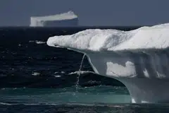 Flowing water from a melting iceberg in Scoresby Fjord, Greenland, August 12, 2023. Since 1990, melting ice in Greenland and Antarctica has slowed down the Earth’s rotation, a study found. This has delayed the need for a negative leap second until at least 2029.