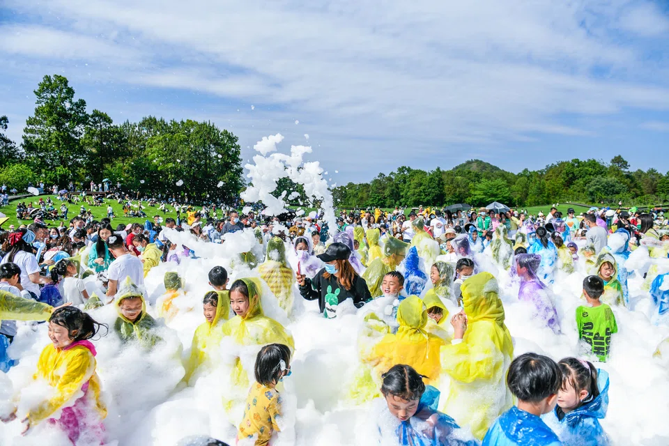 Tourists having fun with bubbles at a park in Qianxinan in China's south-western Guizhou province. China's tourism sector has been among the hardest hit by Beijing's zero-Covid policy, which demands that each flare-up be detected and contained as quickly as possible. 