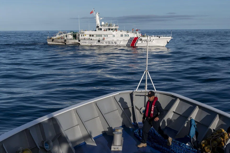 A China Coast Guard ship moves past a Philippine Coast Guard vessel BRP Sindangan, in the disputed Second Thomas Shoal, in the South China Sea, on Nov 10, 2023.