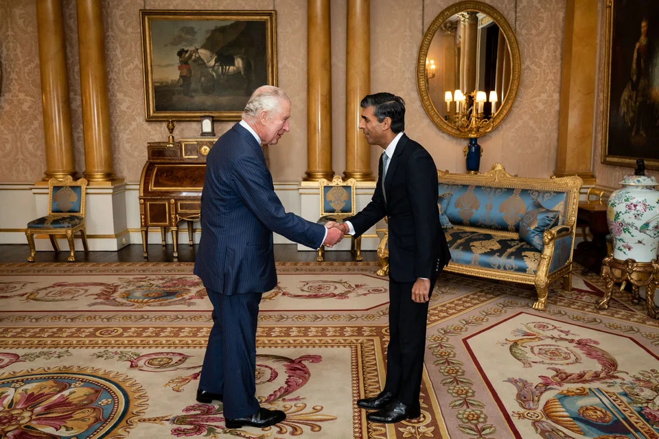Britain's King Charles III greets newly appointed Conservative Party leader and incoming prime minister Rishi Sunak during an audience at Buckingham Palace  where he was invited to form a government. 