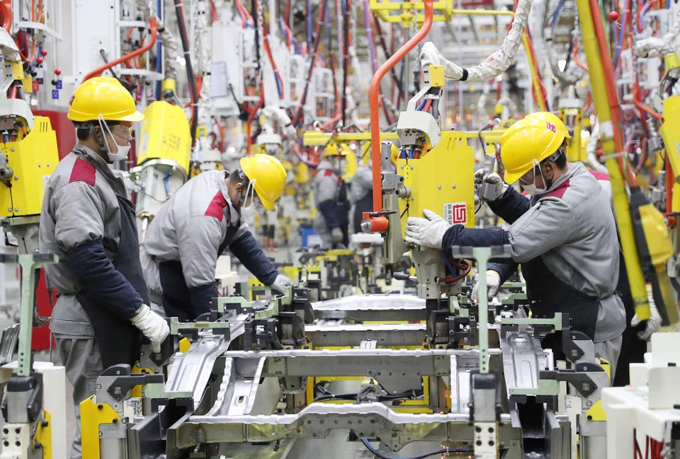 A Jan 2023 photo showing employees at a car assembly line in a Beijing factory in Qingdao, in China's eastern Shandong province.