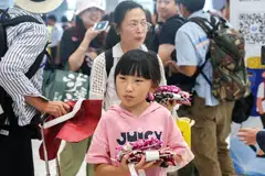 Chinese tourists arrive during a welcome ceremony of the first batch of Chinese tourists under a five-month visa-free entry scheme on Sep 25, 2023.