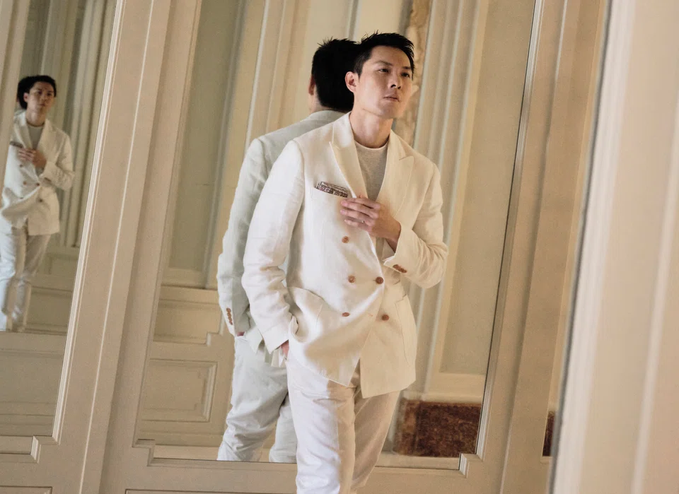 Filmmaker Anthony Chen wears a double breasted suit by Brunello Cucinelli and Berluti shoes.