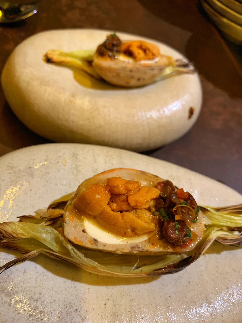 A "scotch egg" of bouncy chicken meatball surrounding a soft-yolked egg topped with uni.