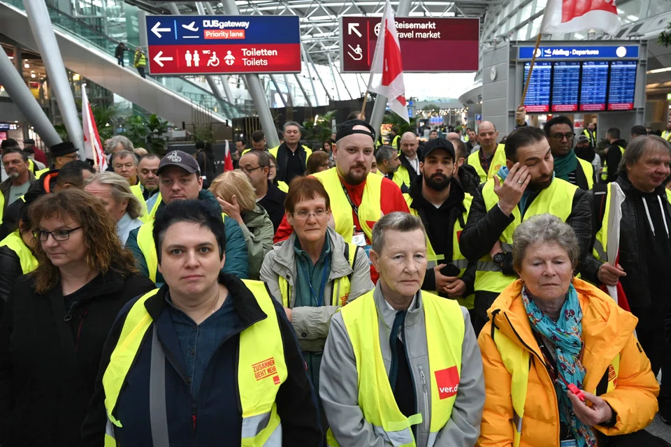 Aviation security staff organised in the public transport sector union ver.di gather for a demonstration during a labour strike at the airport of Duesseldorf, western Germany, on Apr 20.