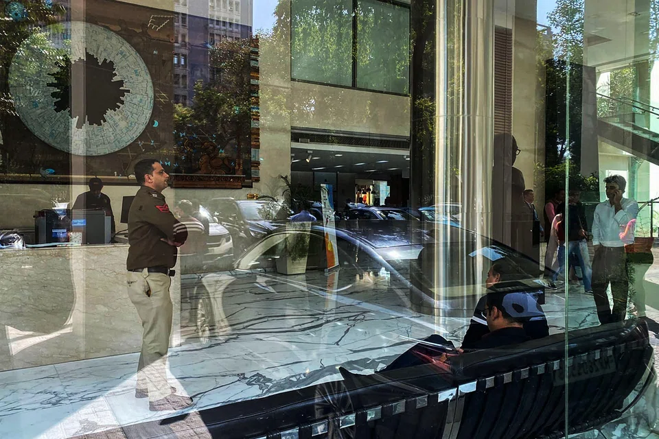 A police officer stands near the reception desk of the office building where Indian tax authorities raided BBC's office in New Delhi on February 14, 2023. 