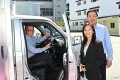 From left: Minister Edwin Tong, Keppel Infrastructure CEO Cindy Lim and Keppel CEO Loh Chin Hua with one of the electric trucks paid for with Keppel's donation.