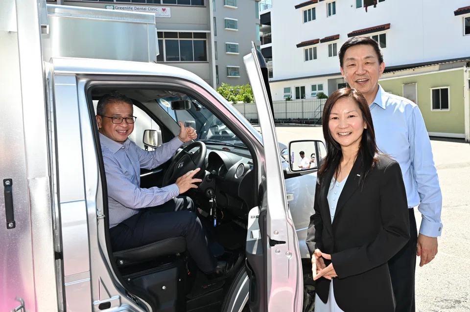 From left: Minister Edwin Tong, Keppel Infrastructure CEO Cindy Lim and Keppel CEO Loh Chin Hua with one of the electric trucks paid for with Keppel's donation.