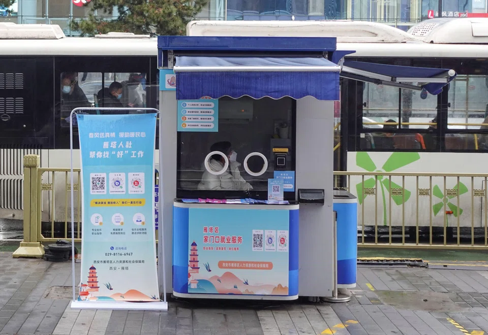 Some of the metal or plastic testing booths that were once ubiquitous symbols of the “zero-Covid” policy have found a new life as mini-pharmacies, shelters or information stations; (above) a job information booth that was transformed from a Covid-19 testing booth in Xian.