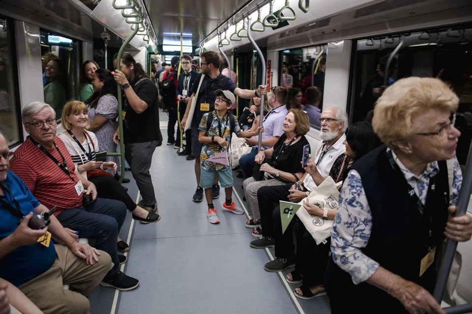 Visitors ride the Reseau Express Metropolitain (REM) light rail during its inauguration ceremony in Montreal, Quebec, Canada, on Friday, July 28, 2023. The train line runs 16.6 kilometres from Gare Centrale to Brossard stations and will open to the public on July 31. Photographer: Andrej Ivanov/Bloomberg
