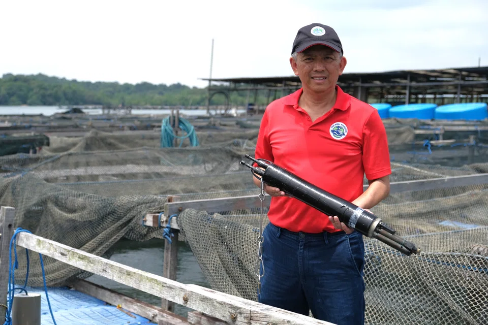 Malcolm Ong, chief executive and founder of The Fish Farmer, with a water quality monitoring sensor that detects changes in water conditions on his farms.