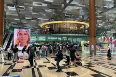 Long queues had formed at Changi Airport, with throngs of people waiting to enter departure gates. 