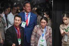 Pheu Thai Party leader Chonlanan Srikaew, local property tycoon and new party adviser Srettha Thavisin, and Paetongtarn Shinawatra, one of  the party's  prime ministerial candidates, attend the draw for the party's list usage for the upcoming election in Bangkok on Tuesday.  