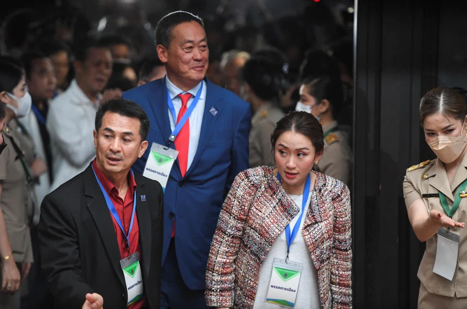 Pheu Thai Party leader Chonlanan Srikaew, local property tycoon and new party adviser Srettha Thavisin, and Paetongtarn Shinawatra, one of  the party's  prime ministerial candidates, attend the draw for the party's list usage for the upcoming election in Bangkok on Tuesday.  