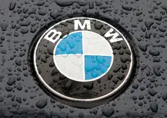 The logo of German car manufacturer BMW is seen on the bonnet of a vehicle covered with water drops in Kiev March 27, 2012.   REUTERS/Str (UKRAINE  - Tags: TRANSPORT BUSINESS LOGO)