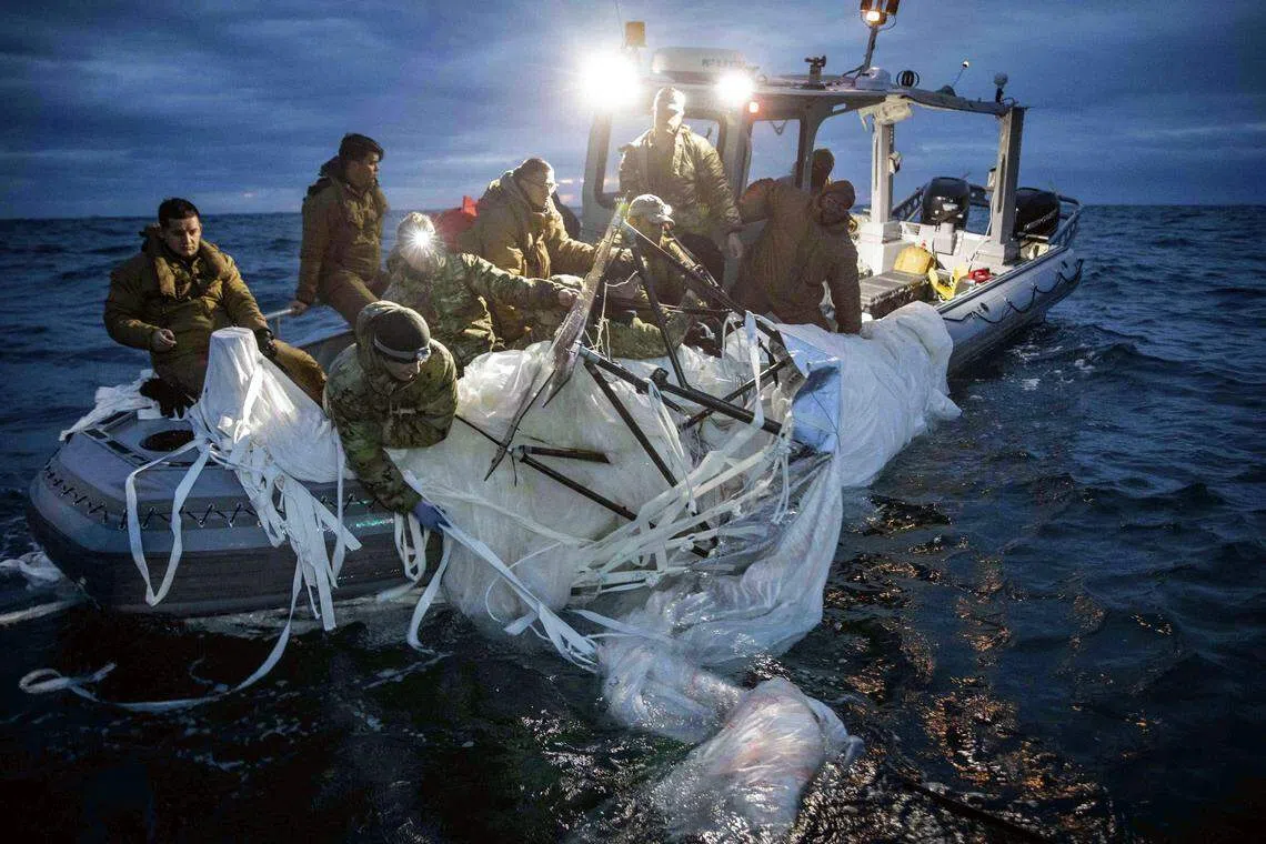 US Navy sailors recover the downed Chinese surveillance balloon off the coast of South Carolina on Feb 5, 2023. The United States has ended its search for debris from an alleged Chinese surveillance balloon it shot down earlier this month as well as two other objects downed near Alaska and on Lake Huron.