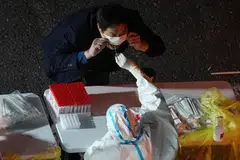 A man gets tested for Covid-19 at a nucleic acid testing site, following an outbreak in Shanghai, China, Nov 9, 2022. 