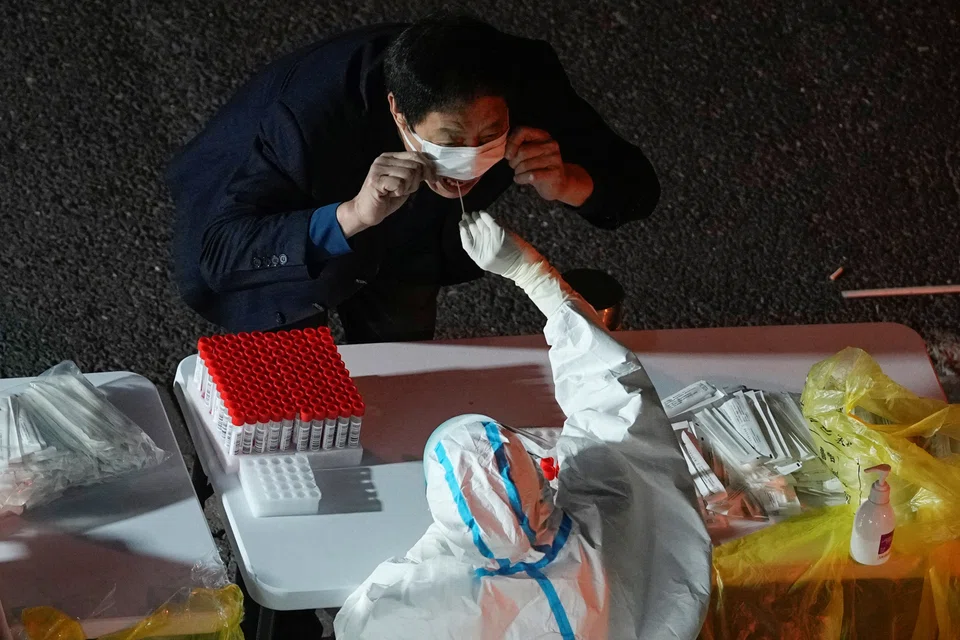A man gets tested for Covid-19 at a nucleic acid testing site, following an outbreak in Shanghai, China, Nov 9, 2022. 