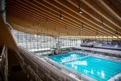 The inward-curving roof of the new aquatic centre saves on heating by reducing enclosed space.