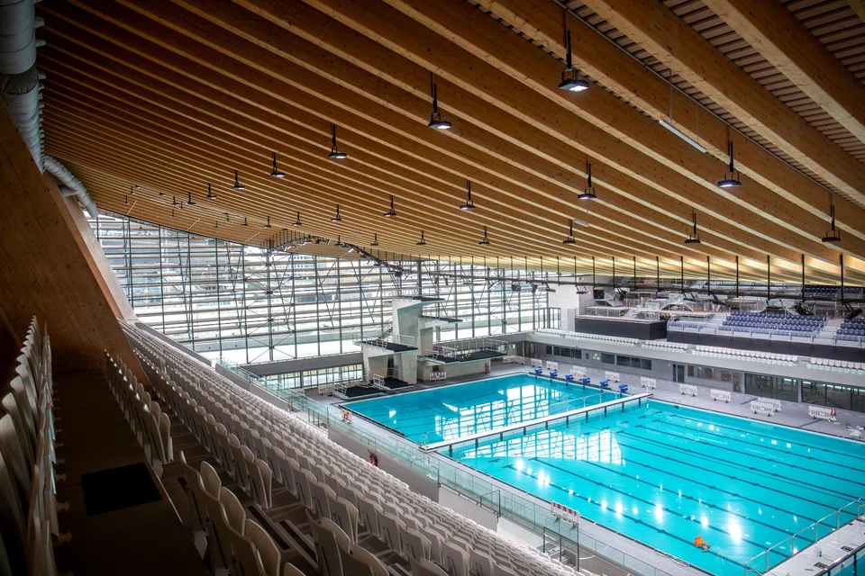 The inward-curving roof of the new aquatic centre saves on heating by reducing enclosed space.