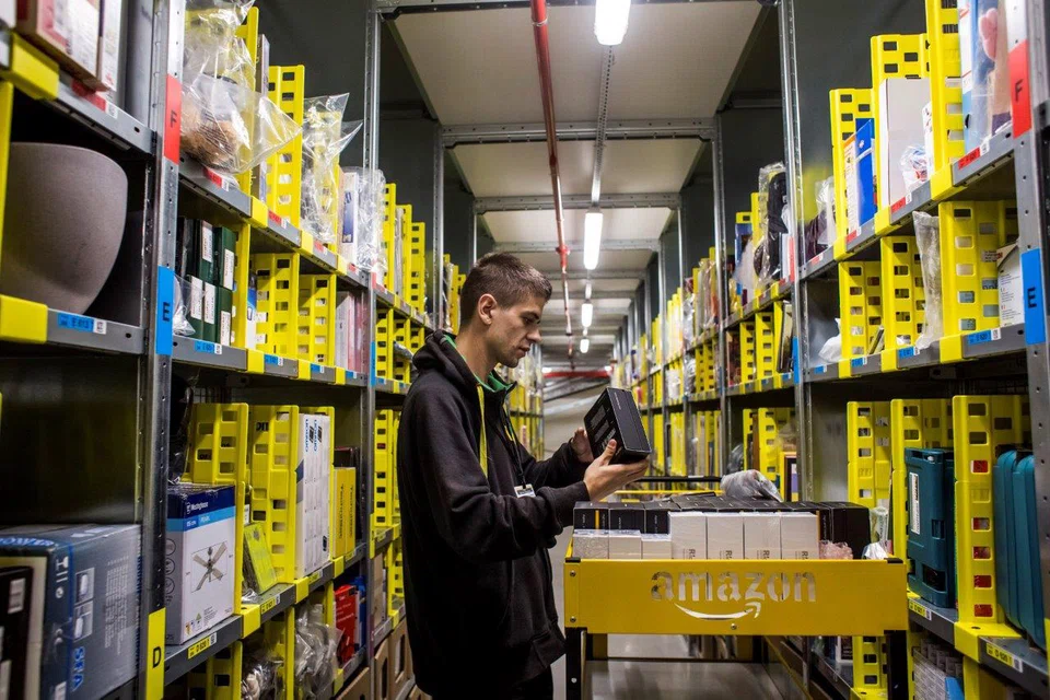 An employee collects customer orders from an aisle in an Amazon.com Inc fulfilment centre in Dobroviz in the Czech Republic. The company now wants to its warehouses to be in urban centres so that orders by online shoppers can be delivered in shorter time - and is taking steps to buy its own space. 